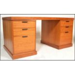 A retro teak wood Danish twin pedestal antique style desk, flared teak top over twin matching