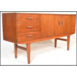 A vintage mid 20th Century Danish influence sideboard having a bank of three drawers beside twin