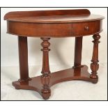 A 19th century Victorian mahogany demi - lune hall table. Raised on turned legs with fitted frieze