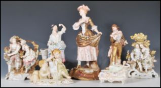 A collection of 20th Century German ceramic figurines to include two Sitzendorf figure groups