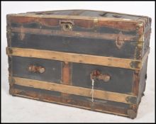 A vintage 19th century wooden and canvas bound steamer trunk. The dome top with open storage within.
