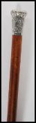 A 20th Century walking stick cane having a malacca shaft with silver knop to the top having repousse
