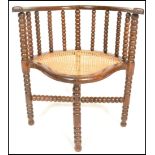 A 19th Century Victorian William and Mary revival corner chair having turned bobbin stretchers to