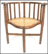 A 19th Century Victorian William and Mary revival corner chair having turned bobbin stretchers to