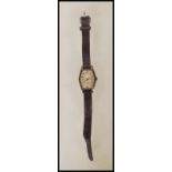 An Art Deco hallmarked silver watch with leather strap having an engine turned face with