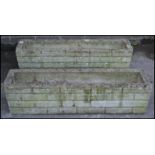 A pair of 20th Century well weather reconstituted garden planters of rectangular trough form,