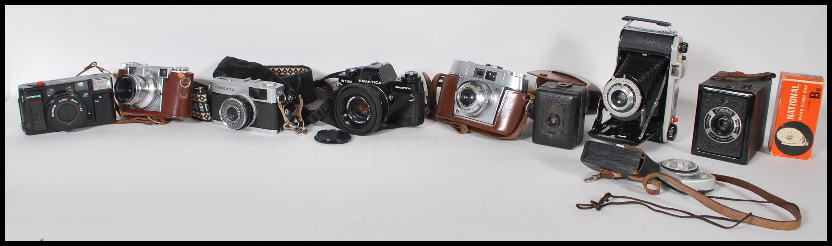 A collection of vintage film cameras to include a Praktica B100 film camera, an Olympus Quick