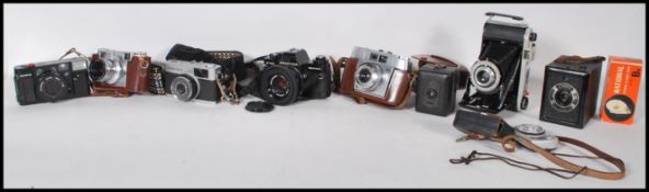 A collection of vintage film cameras to include a Praktica B100 film camera, an Olympus Quick