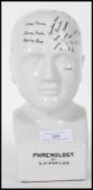 A 20th Century antique style phrenology head having a white crackle glaze with labelling to the