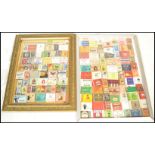Two antique glazed picture frames having a montague of vintage 20th Century cigarette packets from
