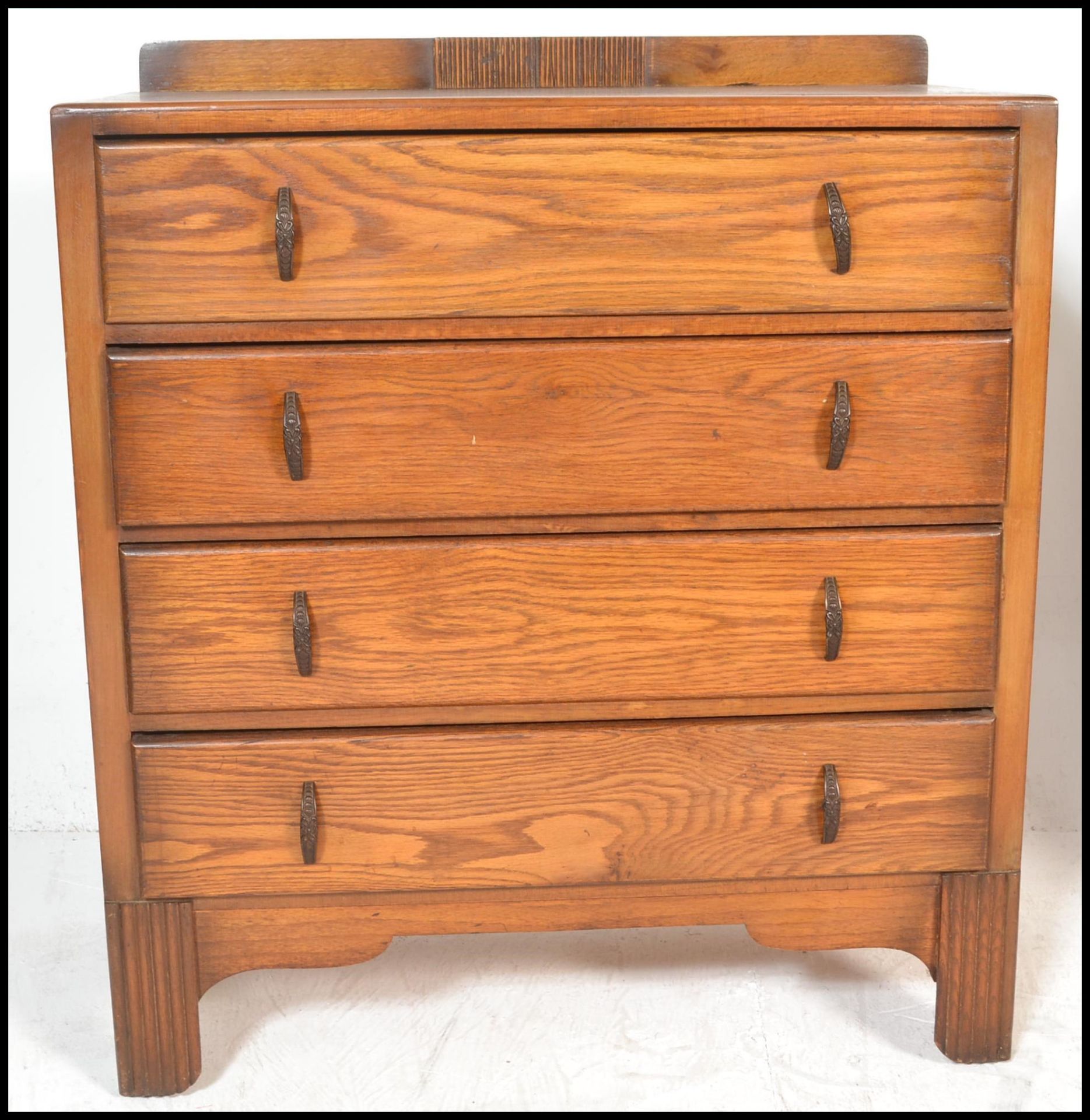 A 1930's Art Deco oak chest of drawers being raised on bracket feet with a  bank of 4 drawers having - Image 4 of 9