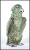 A German cold painted bronze inkwell in the form of a parrot finished in a green colourway with