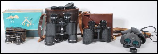 A group of vintage binoculars to include a pair of Carl Zeiss Jena Jenoptem 8 x 30 W binoculars in