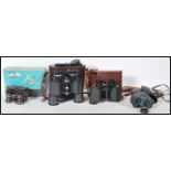 A group of vintage binoculars to include a pair of Carl Zeiss Jena Jenoptem 8 x 30 W binoculars in