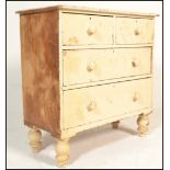 A Victorian 19th century shabby chic painted cottage chest of drawers. Raised on bun feet with 2