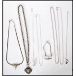 A group of silver necklace chains and pendants to include a rolo chain, a triple link cross over