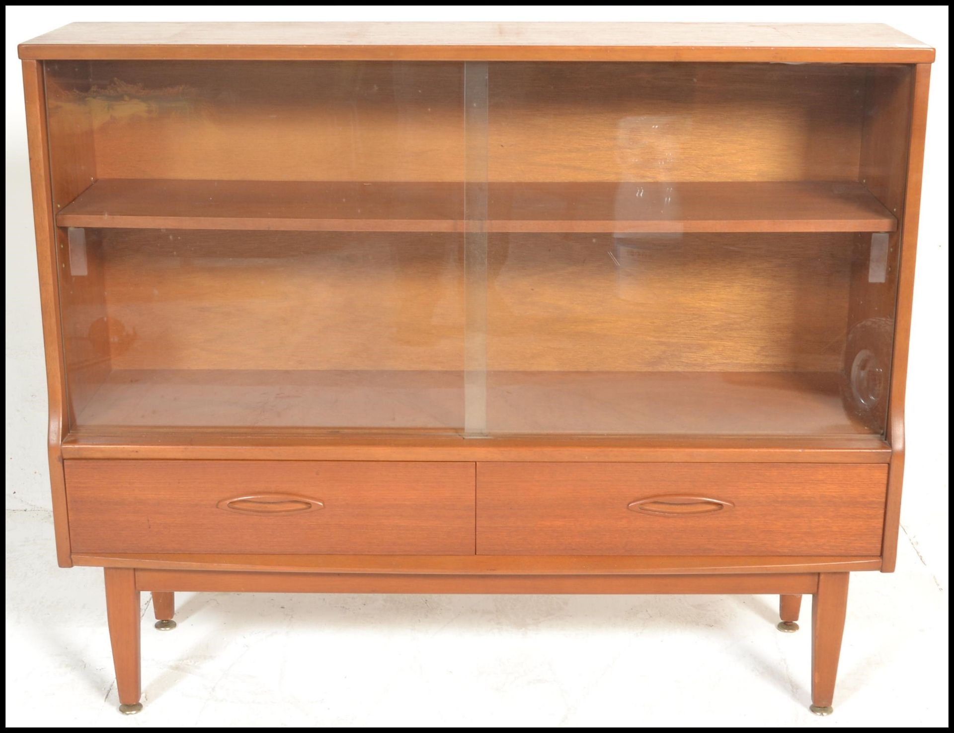 A retro 20th Century teak wood display cabinet having twin glass sliding doors with a shelved - Image 2 of 5