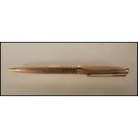 A vintage stamped 9ct gold Parker ballpoint writing pen having engine turned decoration having a