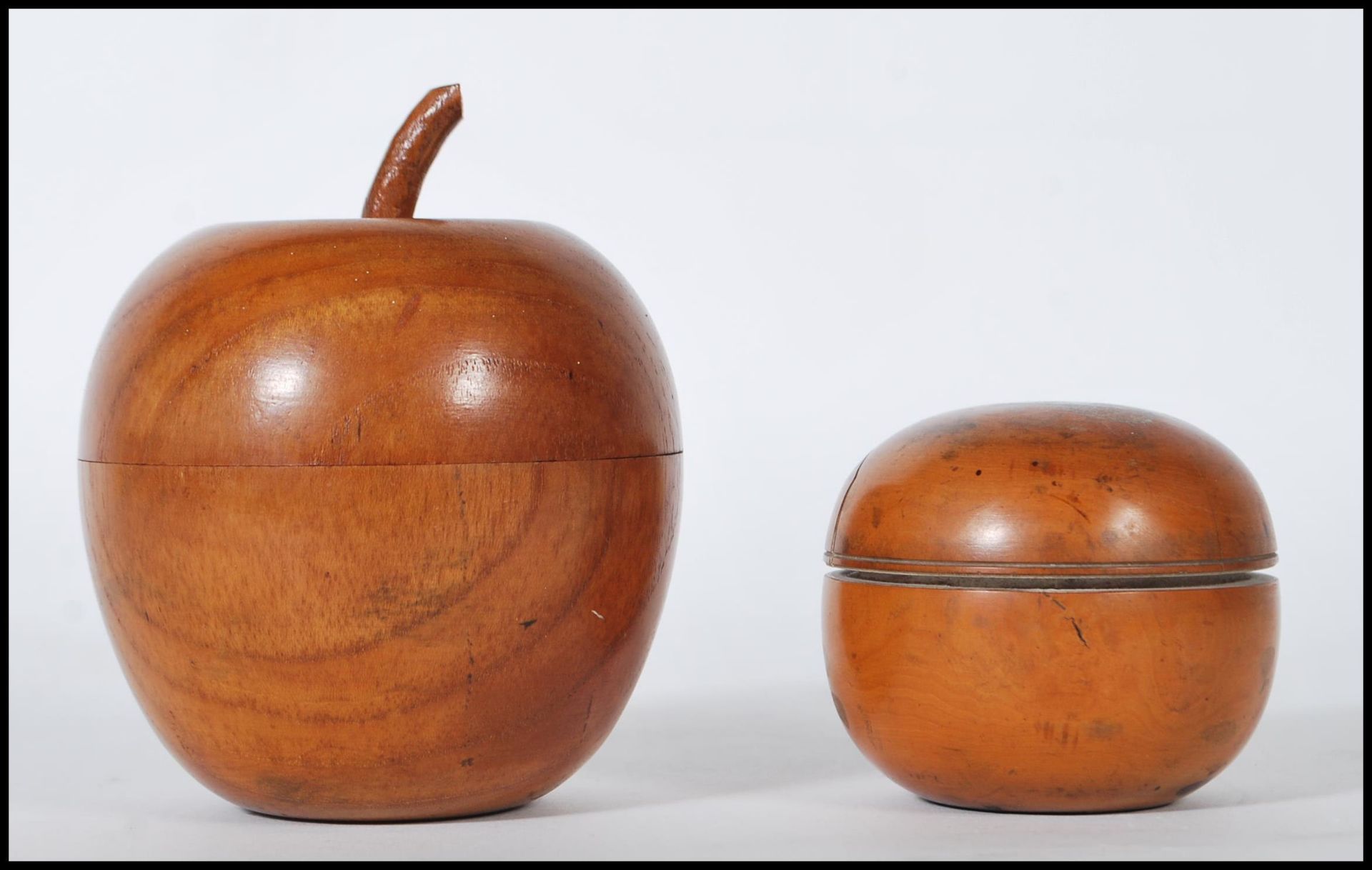 A 20th Century carved wood tea caddy in the form of an apple together with an olive wood dressing