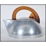 A vintage 20th Century polished stove top kettle by Piquot ware, teak wood handle to the top with