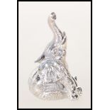 A stamped sterling silver figure in the form of a elephant seated raising his trunk. Weighs 17.5g