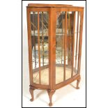 A early 20th Century 1930's Art Deco walnut demi lune china display cabinet. Raised on cabriole legs