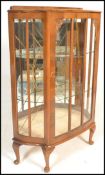 A early 20th Century 1930's Art Deco walnut demi lune china display cabinet. Raised on cabriole legs