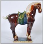 A good 20th Century Chinese Tang dynasty style war horse moulded to a rectangular ceramic base.