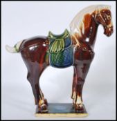 A good 20th Century Chinese Tang dynasty style war horse moulded to a rectangular ceramic base.