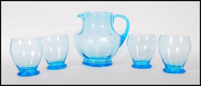 A vintage mid 20th Century 1950's blue glass lemonade set consisting of pitcher jug and four glasses