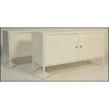 A pair of contemporary metal locker style  sideboard credenzas, each finished in a white colourway