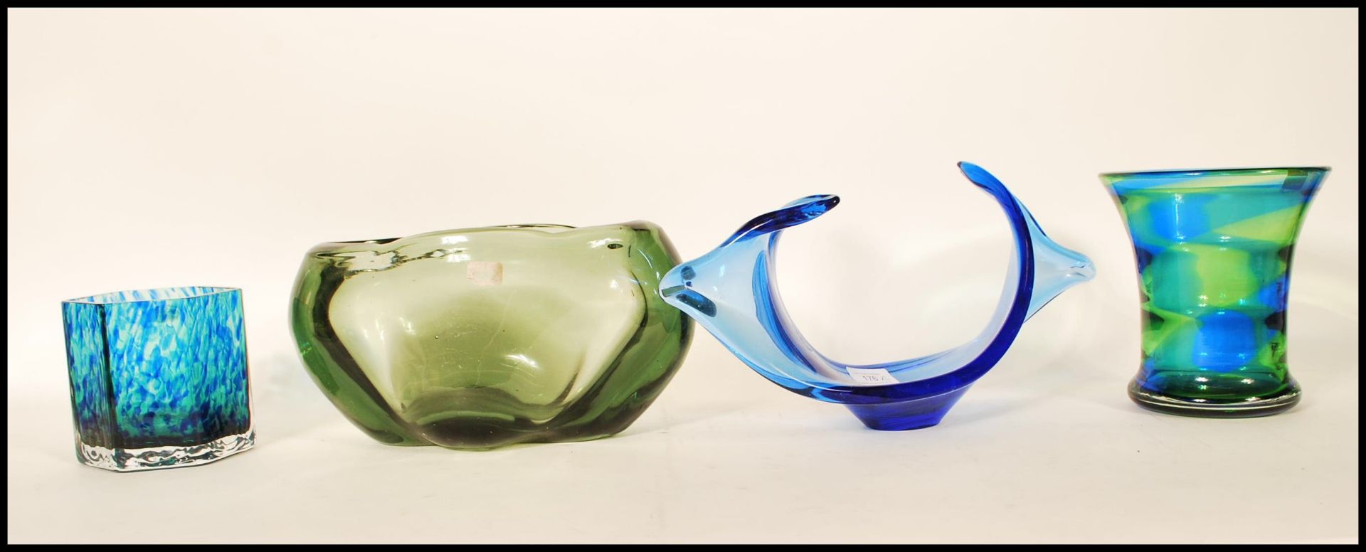 A selection of 20th Century retro studio glass to include a blue and green rainbow glass vase in the