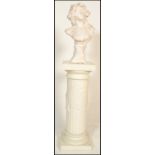A 20th Century antique style cast plaster bust of classical form depicting a female nude raised on a