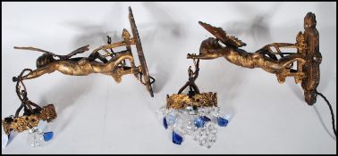 A pair of 20th Century wall mounted gilt cast metal light fixture chandeliers in the form of cherubs