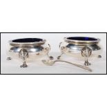 A pair of 19th Century Victorian silver hallmarked table salt condiments of round form having