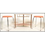 A pair of vintage stools having orange crackle leather round pad seats raised on four chromed