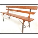 A 20th Century Victorian style pine station bench, raised on upright metal supports with plank