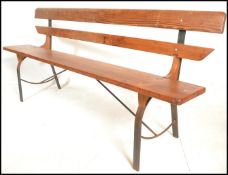 A 20th Century Victorian style pine station bench, raised on upright metal supports with plank