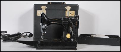 A Vintage 195o's Singer portable electric sewing machine model 221K, with rotary hook and reverse