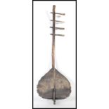 A 20th Century Kenyan tribal Orutu strung musical instrument having a hollow body with a bowed
