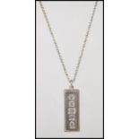 A silver ingot pendant hallmarked for Sheffield 1977 on a belcher link silver chain with a spring
