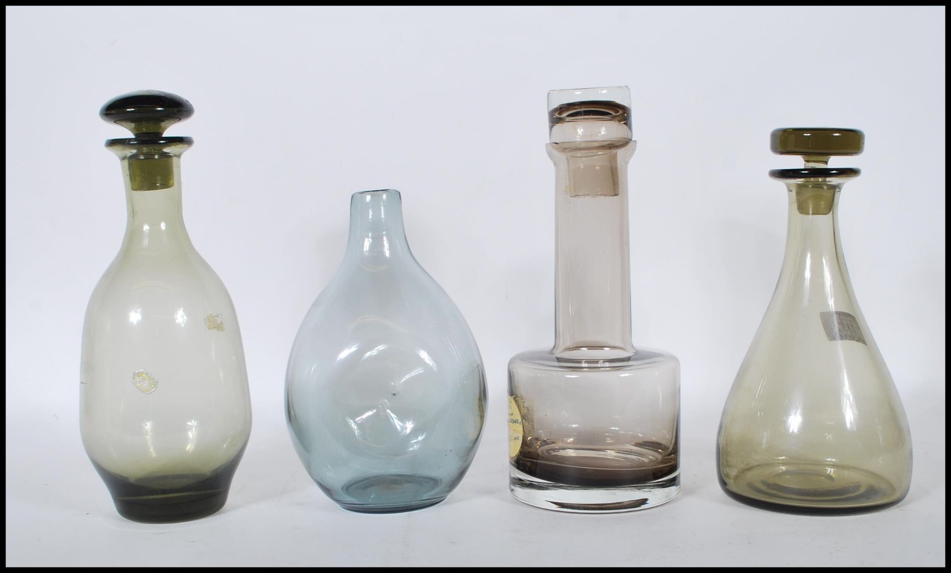 A collection of mid 20th Century 1970's Scandinavian coloured glass decanters and vases to include