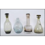 A collection of mid 20th Century 1970's Scandinavian coloured glass decanters and vases to include