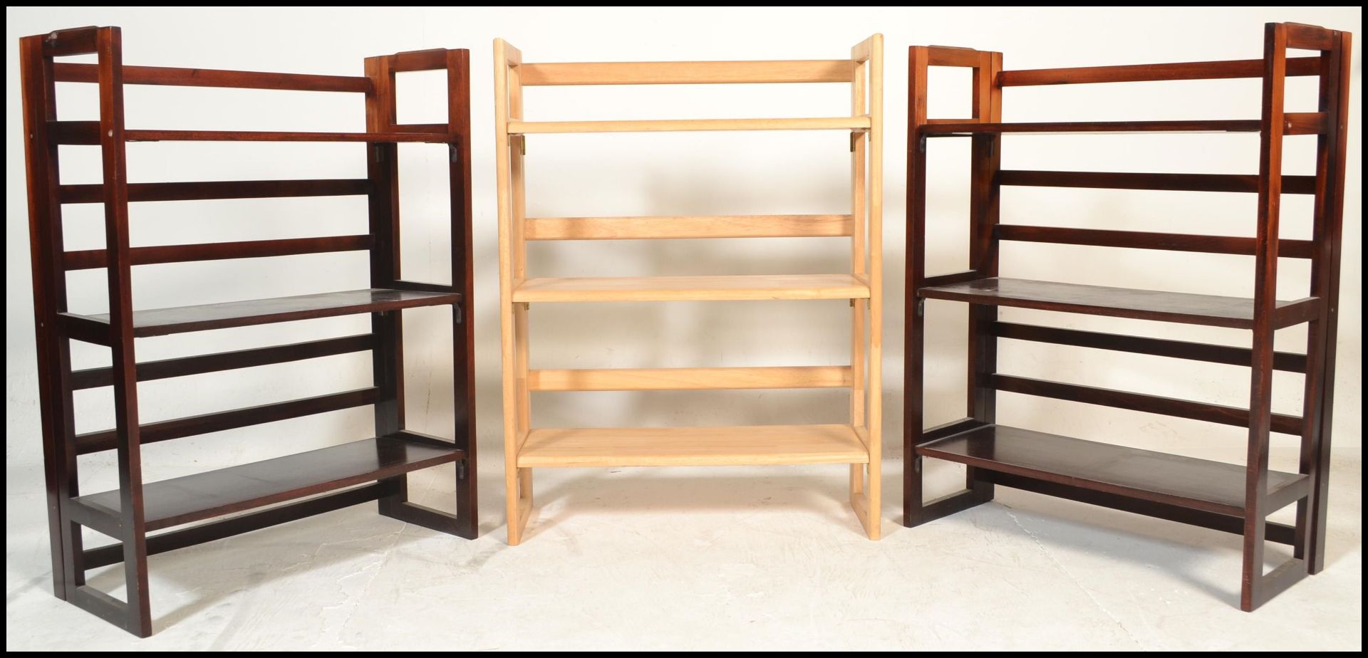 A pair of vintage style 20th Century wooden folding metamorphic bookcases / traders display shelves.