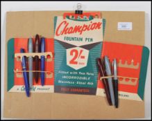A 20th Century vintage retro Champion pens advertising shop display board having card pen holders