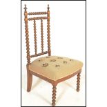 A 19th Century Victorian bobbin framed nursing chair having a stick back with stuffed needlework