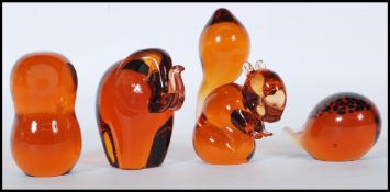 A group of four vintage 20th Century Wedgwood studio glass amber glass paperweights in the form of