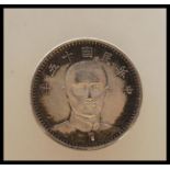 A China 1926 Dollar Type II Sun Yat-sen Silver Yuan coin having the head facing front with two