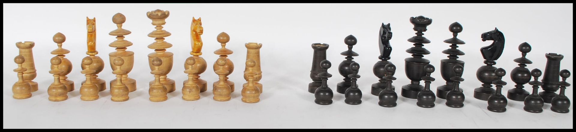 A vintage early 20th Century chess set having a complete set of boxwood and ebonised turned