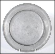 A 19th Century Georgian German pewter plate engraved with initials A M Ue. Base stamped 1827 I.L.
